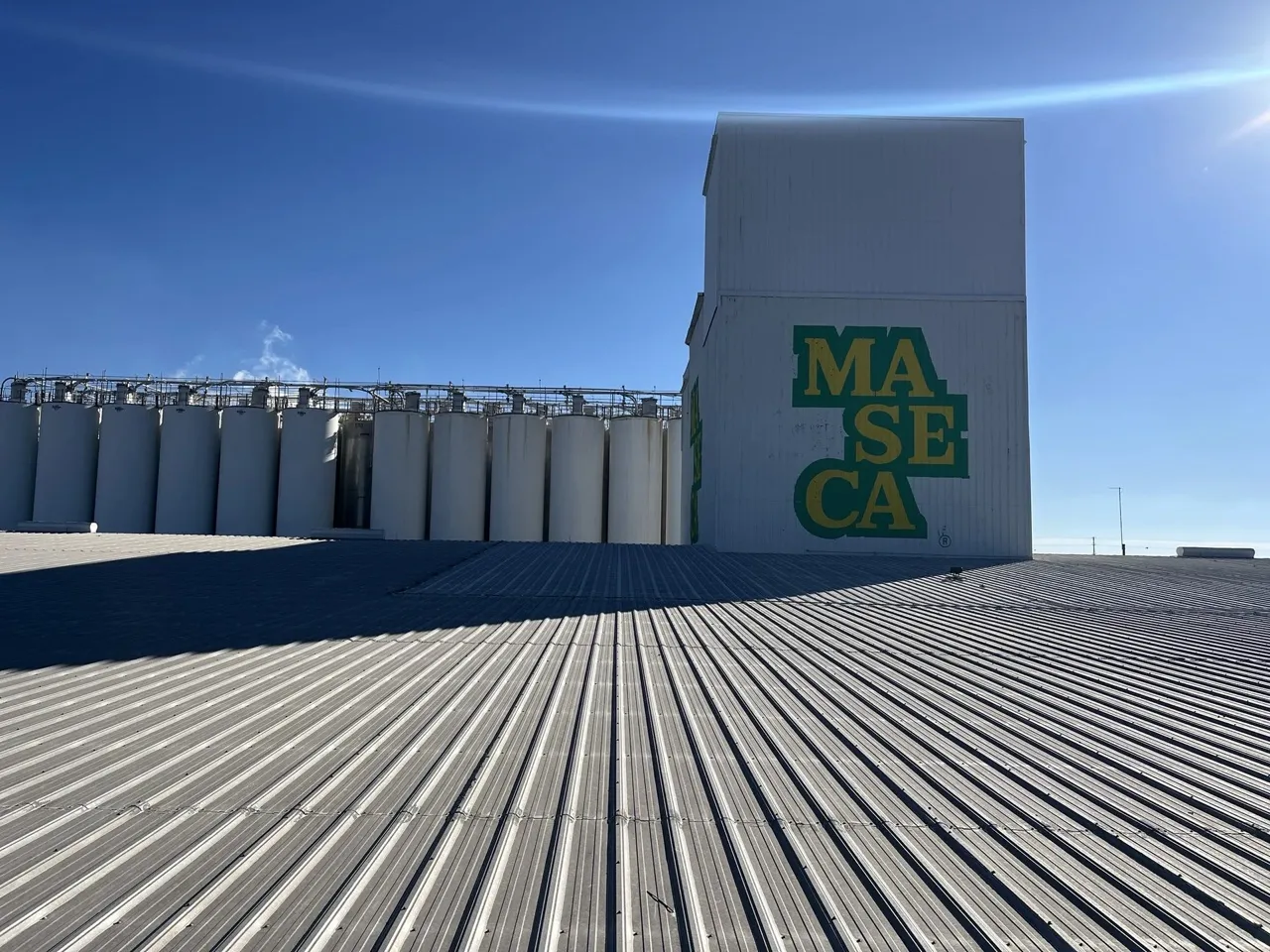 Wide-angle view of a commercial standing-seam metal roof installation on an industrial facility — 5 Star Roofing
