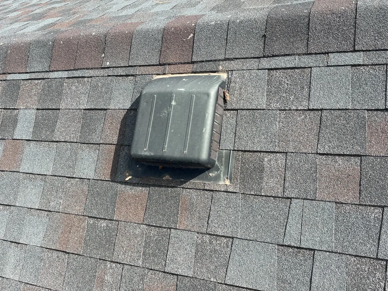 Wind and storm damage on a Perryton, Texas roof with lifted shingles and exposed underlayment