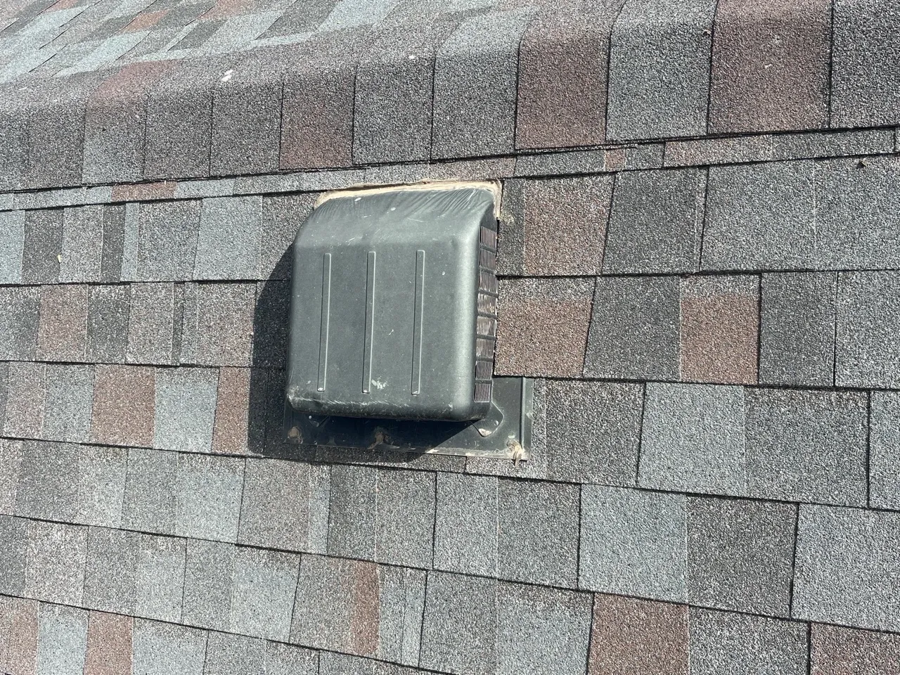 Professional roof inspector examining shingle condition on Amarillo home - Free assessment